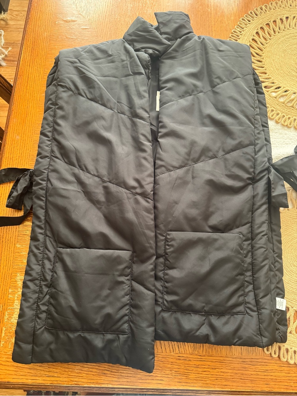 World Market Black Quilted Sleeveless Puffer Vest with bows on side. One size